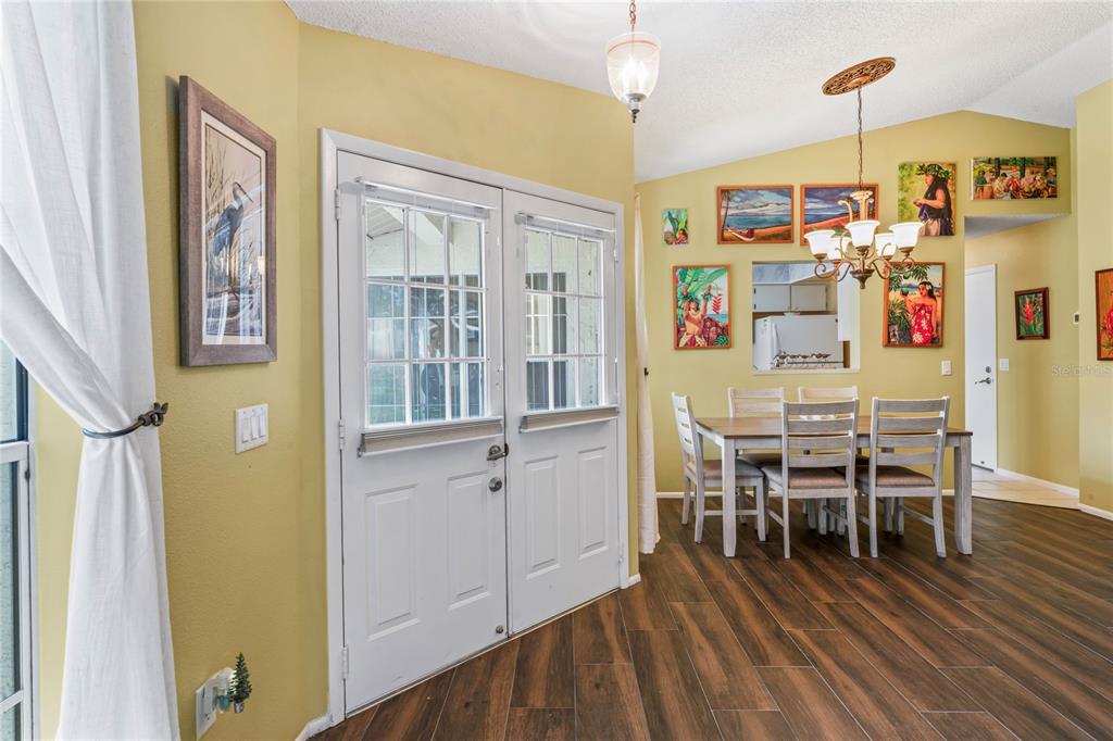 4740 Carrington Court New Port Richey, FL 34655 - Photo 20 of 66 a dining room with furniture a chandelier and wooden floor