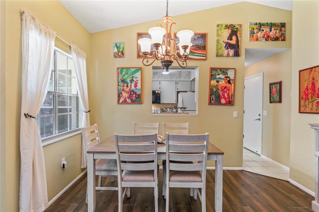 4740 Carrington Court New Port Richey, FL 34655 - Photo 22 of 66 a view of a dining room with furniture window and wooden floor