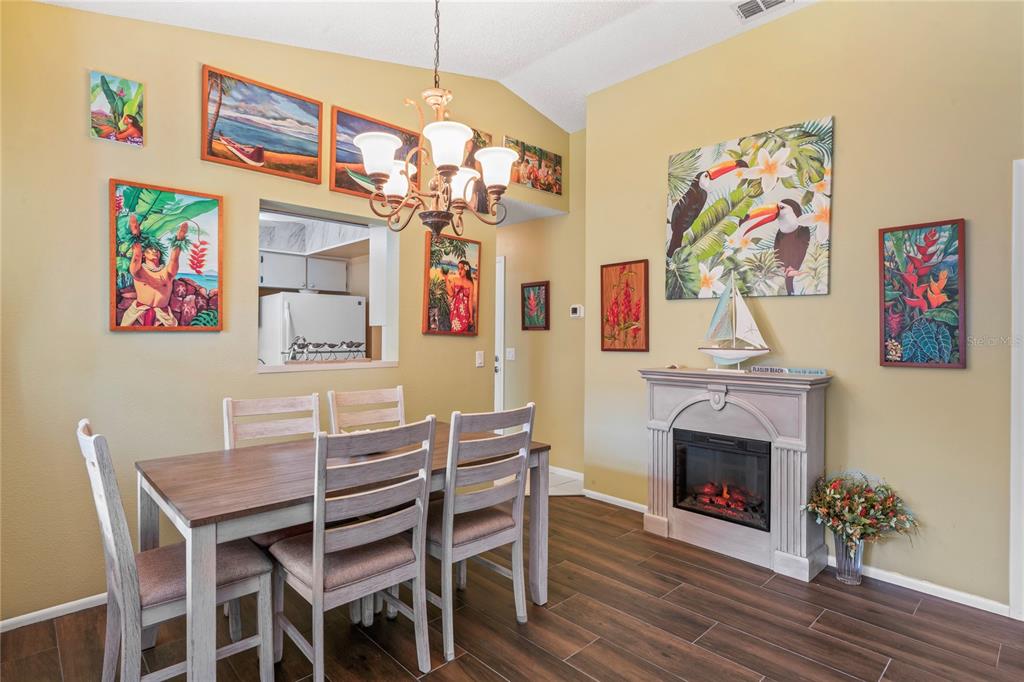 4740 Carrington Court New Port Richey, FL 34655 - Photo 23 of 66 a view of a dining room with furniture wooden floor and a chandelier