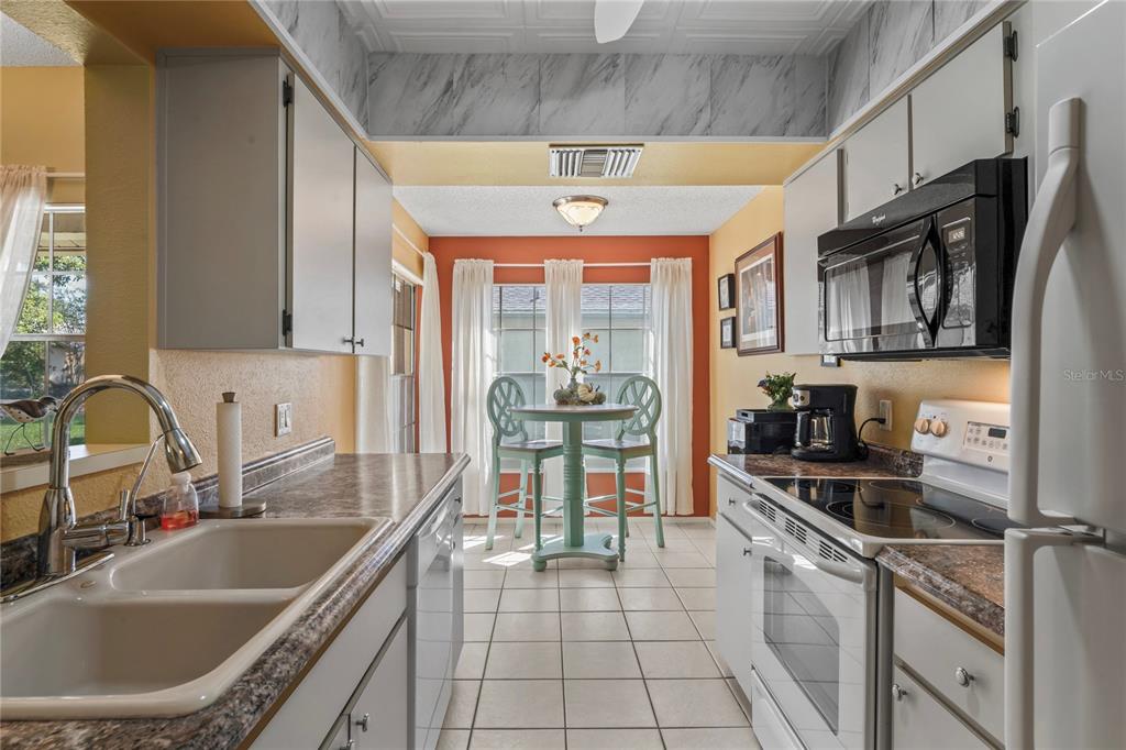 4740 Carrington Court New Port Richey, FL 34655 - Photo 24 of 66 a kitchen with stainless steel appliances granite countertop a sink and cabinets