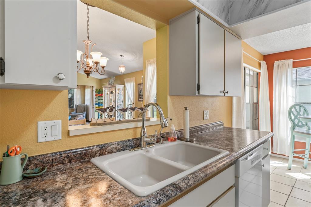 4740 Carrington Court New Port Richey, FL 34655 - Photo 25 of 66 a kitchen with a sink and a wooden cabinets