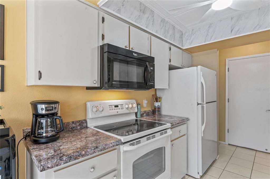 4740 Carrington Court New Port Richey, FL 34655 - Photo 26 of 66 a kitchen with granite countertop a sink stove and refrigerator
