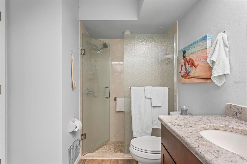4740 Carrington Court New Port Richey, FL 34655 - Photo 35 of 66 a bathroom with a granite countertop toilet sink and shower