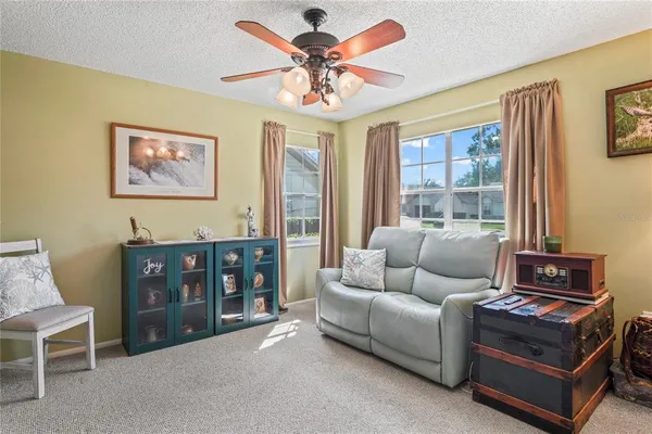 a living room with furniture and a book shelf