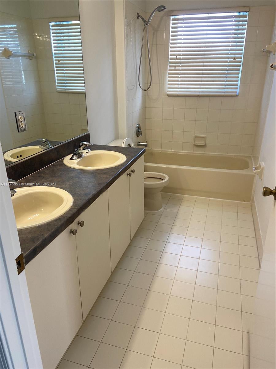 2001 Southwest 157th Avenue Miramar, FL 33027 - Photo 12 of 20 a bathroom with a granite countertop sink a toilet and mirror