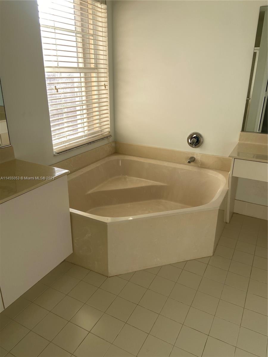 2001 Southwest 157th Avenue Miramar, FL 33027 - Photo 13 of 20 a white bath tub sitting in a bathroom next to a window