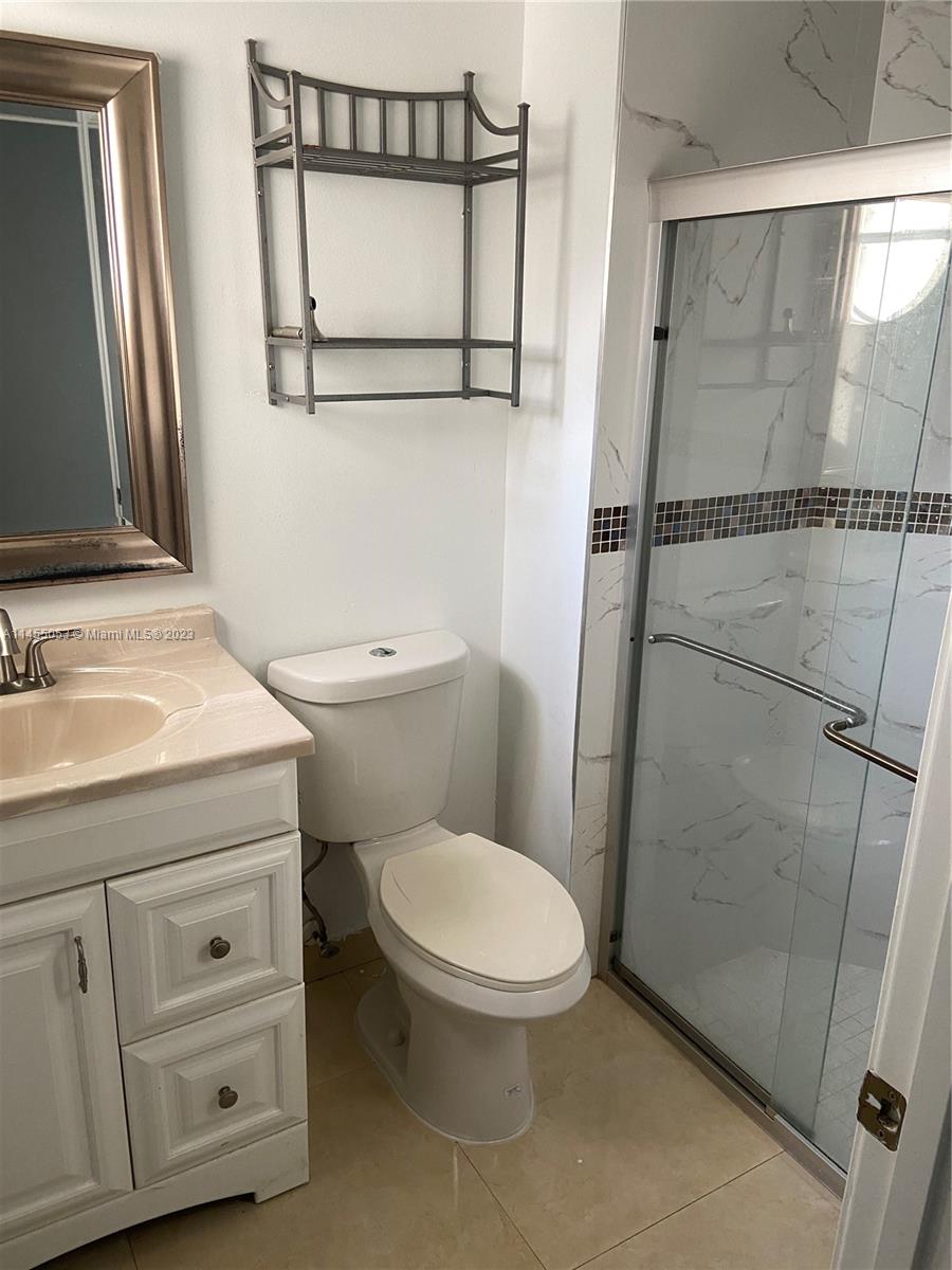 2001 Southwest 157th Avenue Miramar, FL 33027 - Photo 15 of 20 a bathroom with a toilet a sink and a mirror