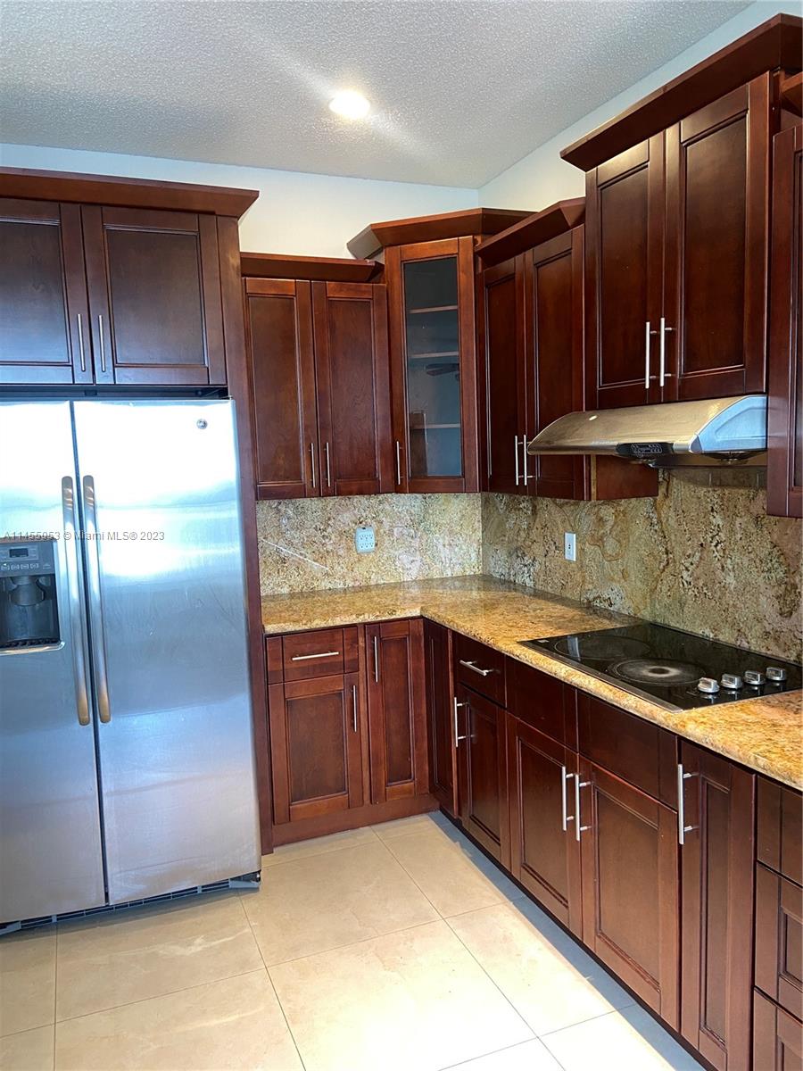 2001 Southwest 157th Avenue Miramar, FL 33027 - Photo 2 of 20 a kitchen with stainless steel appliances granite countertop wooden cabinets a refrigerator and a sink