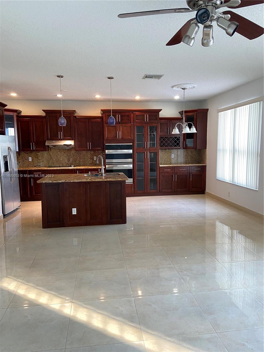 2001 Southwest 157th Avenue Miramar, FL 33027 - Photo 3 of 20 a large kitchen with stainless steel appliances a large counter top