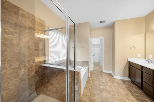 a bathroom with a shower and a sink