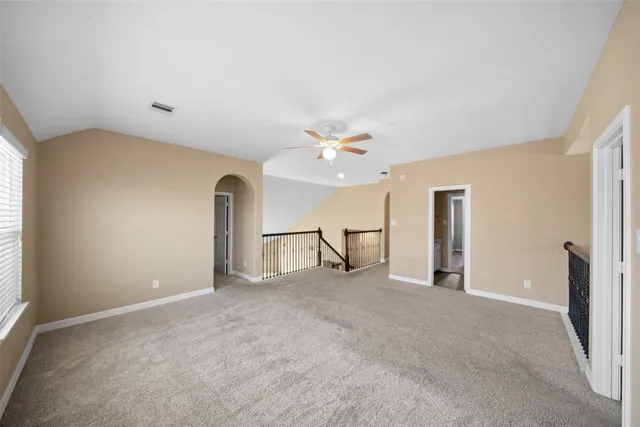 a view of a livingroom with a ceiling fan and window