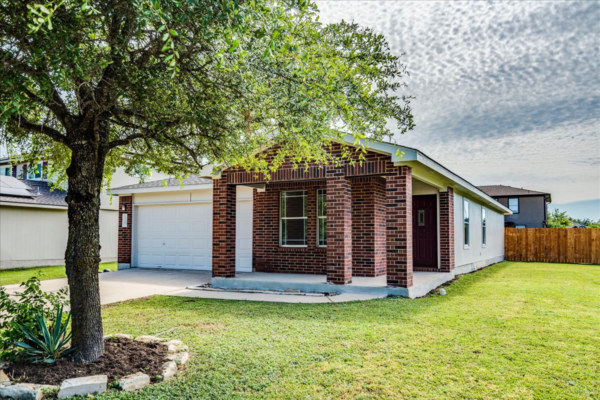100 Easy Street Hutto, TX 78634 - Photo 2 of 36 A classic brick and siding home with a welcoming covered entry and an attached garage.