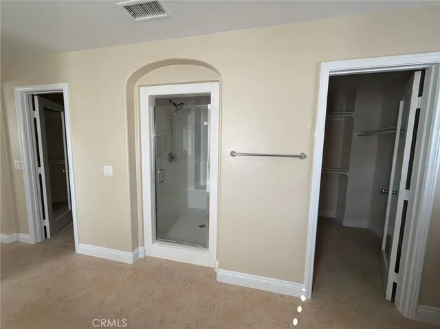 a white toilet sitting in a bathroom next to a window