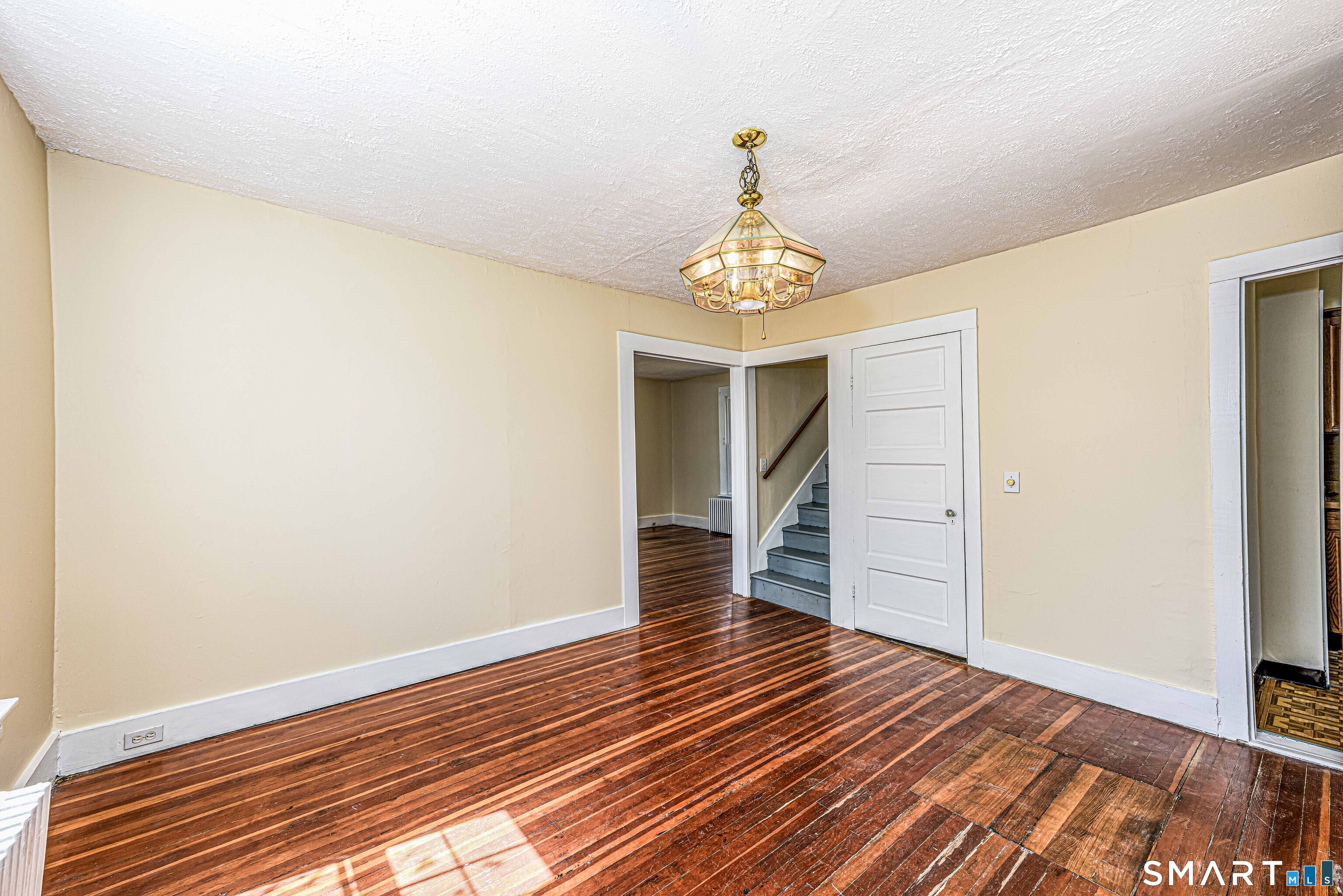 45 Rimmon Road North Haven, CT 06473 - Photo 14 of 40 Dining room shows the living room entrance on left, stairs, basement door, and the kitchen entrance on the right.