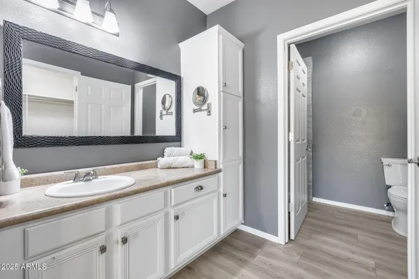 a kitchen with a sink cabinets stainless steel appliances and a window