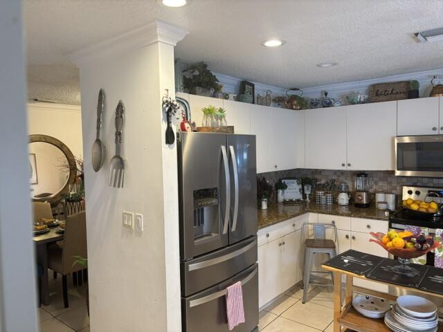 6207 Adriatic Way West Palm Beach, FL 33413 - Photo 13 of 26 a kitchen with stainless steel appliances granite countertop a refrigerator and a stove top oven