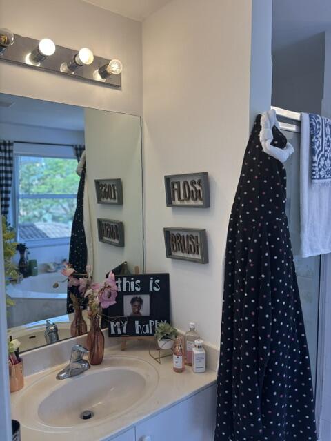 6207 Adriatic Way West Palm Beach, FL 33413 - Photo 20 of 26 a bathroom with a sink a large mirror and a shower