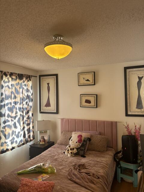 6207 Adriatic Way West Palm Beach, FL 33413 - Photo 22 of 26 a bedroom with a bed and couch