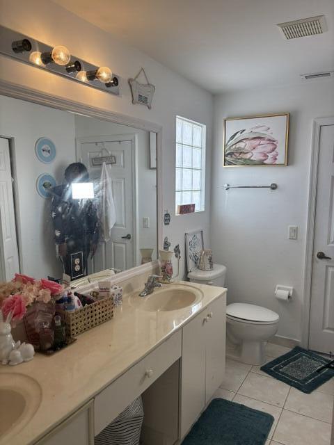 6207 Adriatic Way West Palm Beach, FL 33413 - Photo 23 of 26 a bathroom with a sink a toilet a mirror and shower
