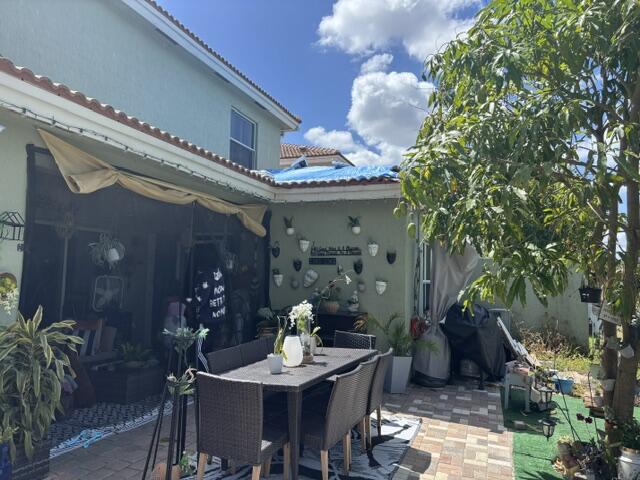 6207 Adriatic Way West Palm Beach, FL 33413 - Photo 5 of 26 a view of a dining room with furniture and chandelier