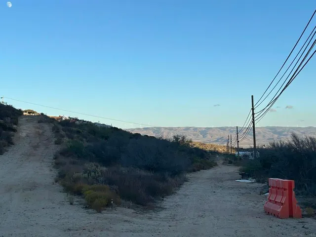 a view of a roof deck with table and chairs