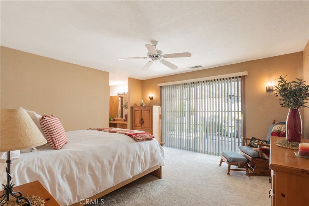 2085 Hanging Tree Lane Templeton, CA 93465 - Photo 13 of 33 Spacious and comfortable primary bedroom with ceiling fan and a large sliding door to the rear covered patio area.