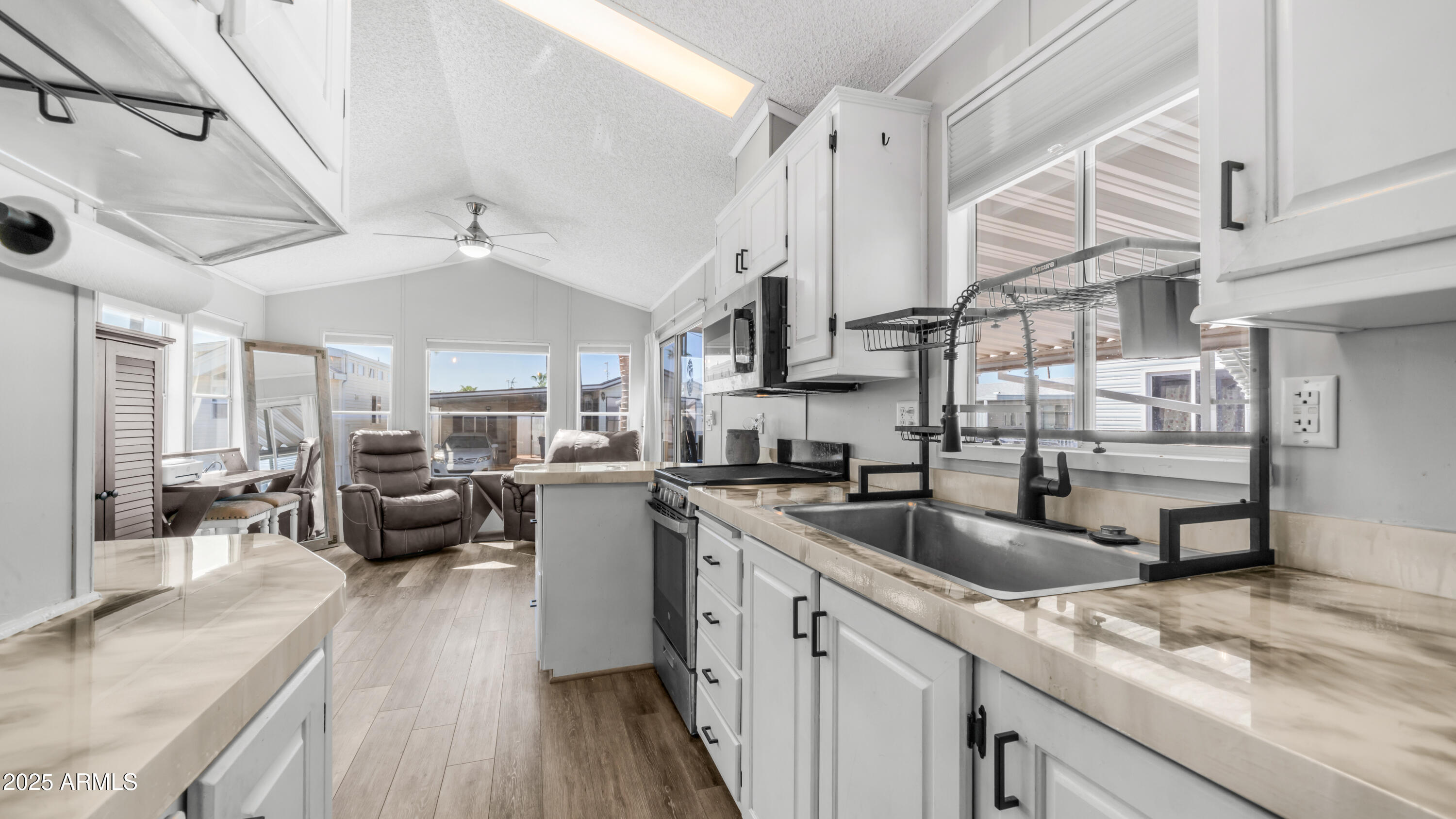 a kitchen with counter top space a sink cabinets and appliances