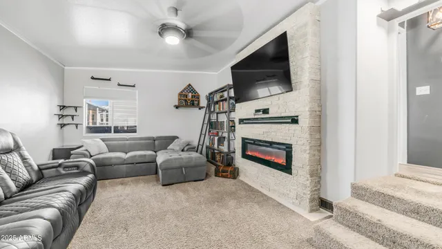 a living room with furniture a flat screen tv and a fireplace