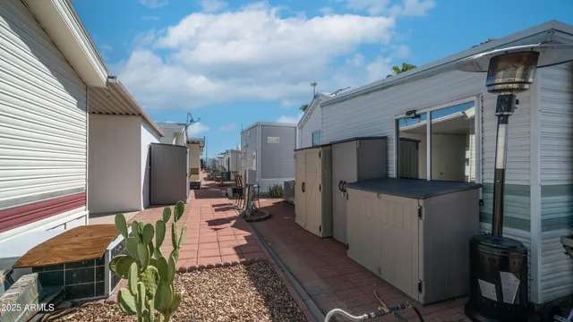 a view of a house with a yard table and chairs