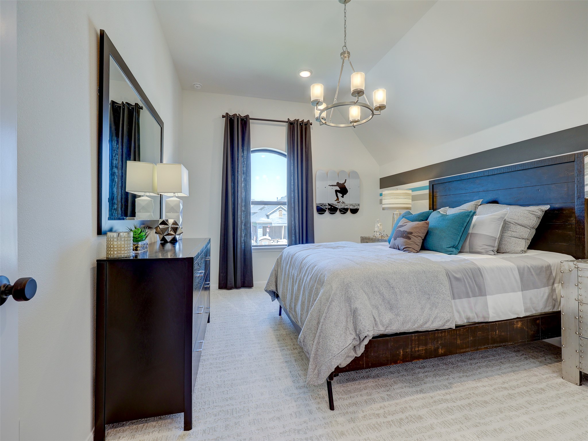 6220 Bower Well Road Austin, TX 78738 - Photo 22 of 28 This cozy bedroom features a vaulted ceiling and a chandelier, creating a comfortable and inviting retreat.