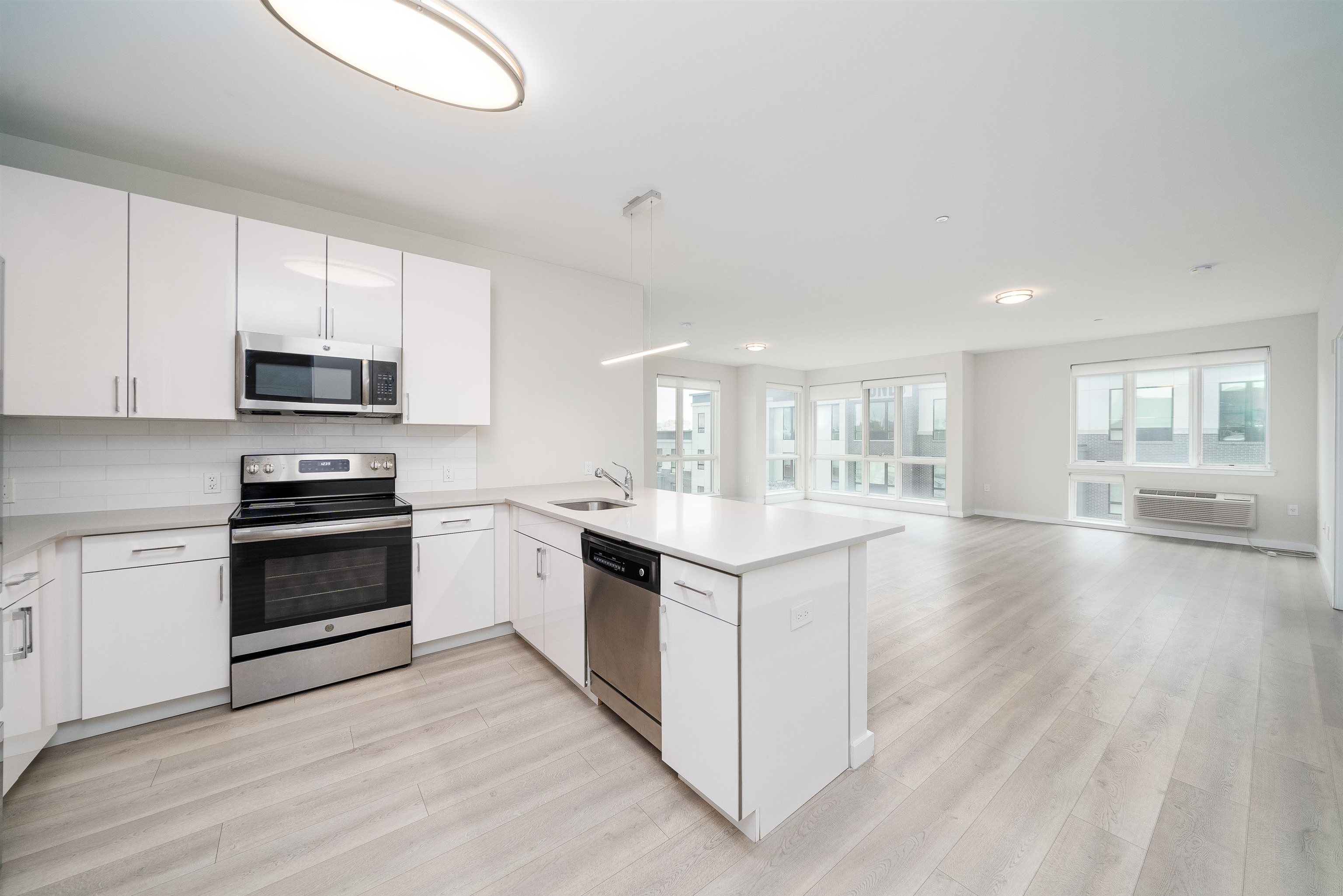 16 Bennett Street, Unit 211 Jersey City, NJ 07304 - Photo 1 of 24 a kitchen with granite countertop a stove top oven and cabinets