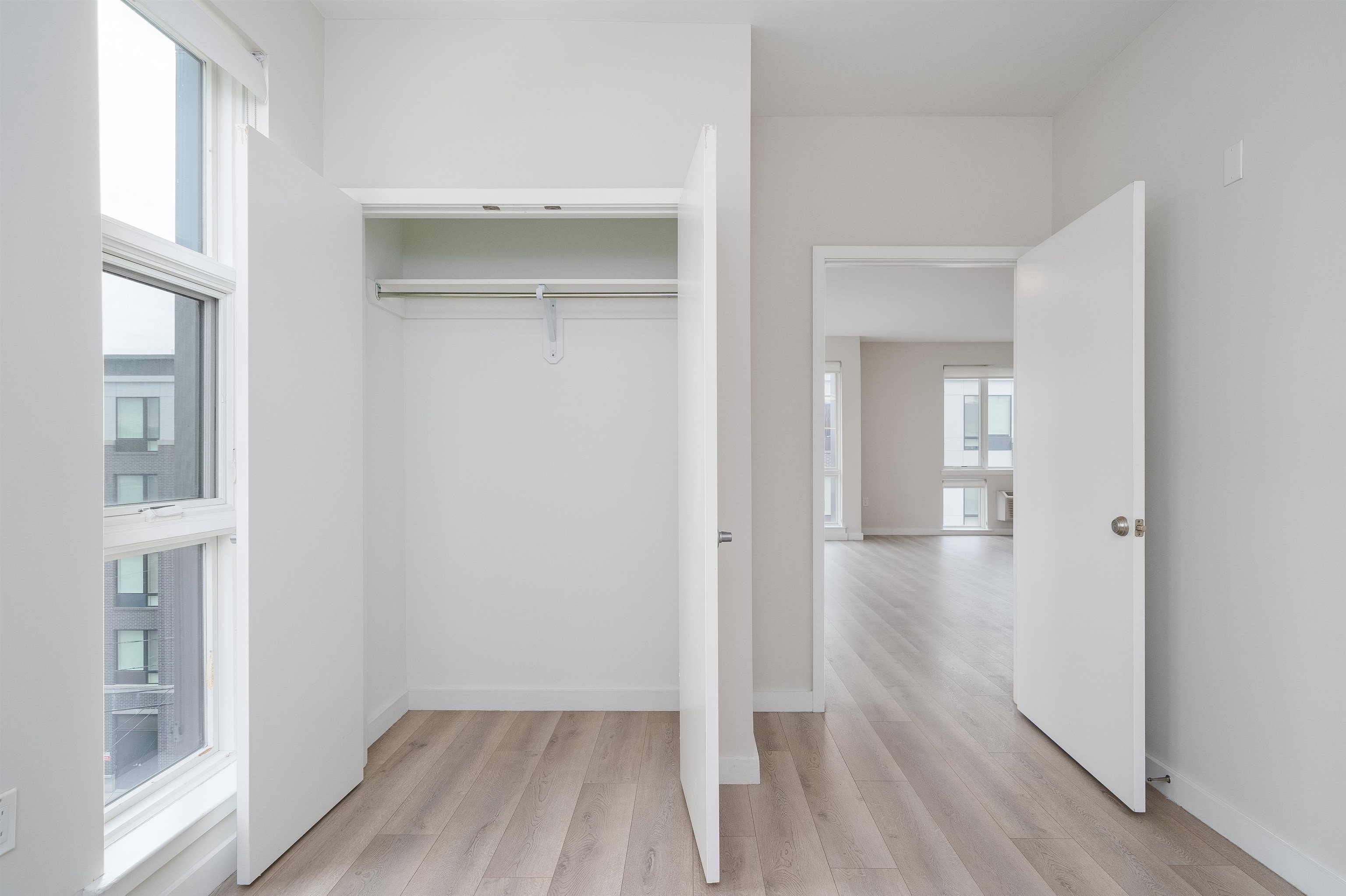 16 Bennett Street, Unit 211 Jersey City, NJ 07304 - Photo 5 of 24 a view of a room with wooden floor and a bathroom