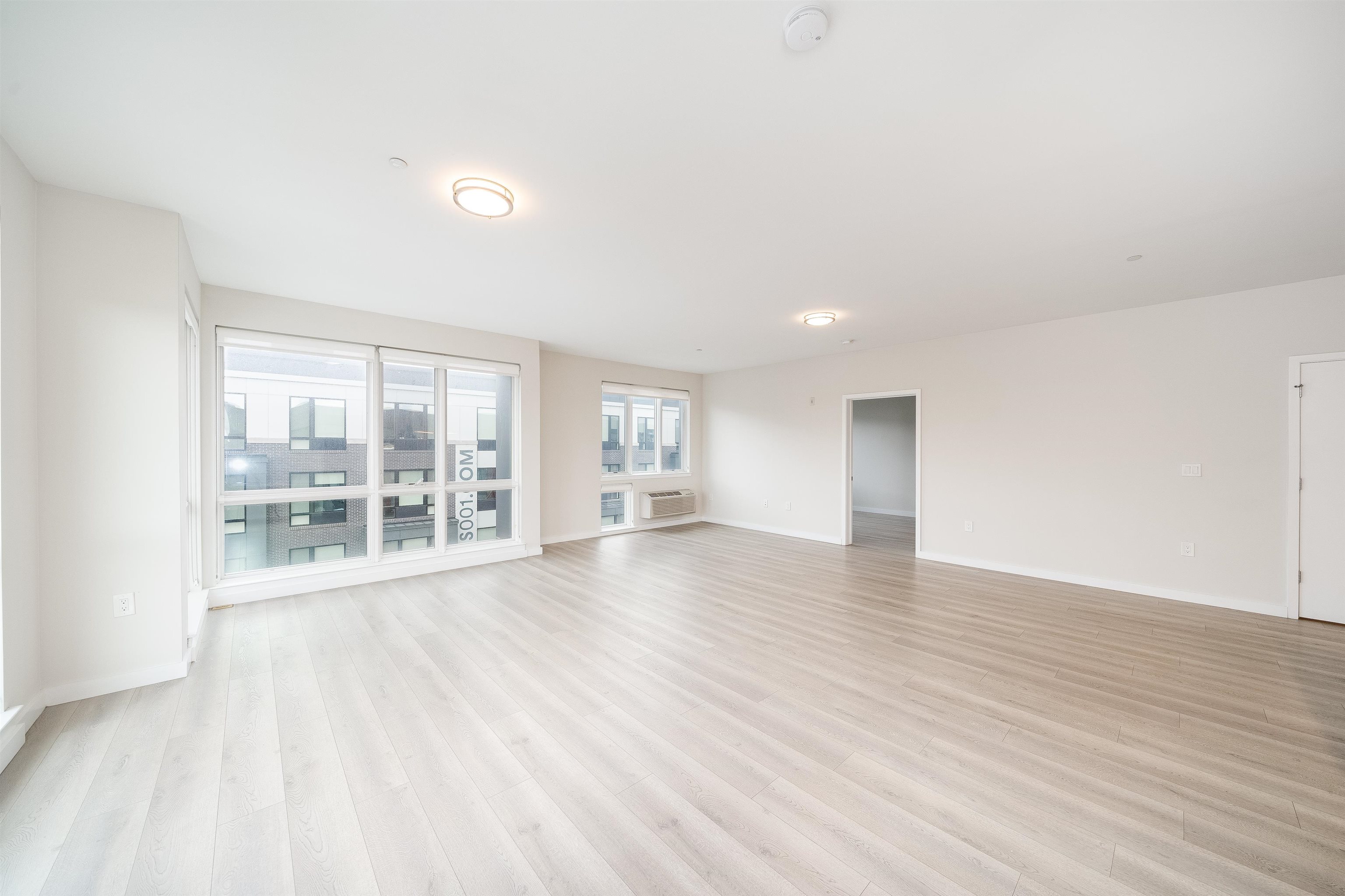 16 Bennett Street, Unit 211 Jersey City, NJ 07304 - Photo 7 of 24 wooden floor in an empty room with a window