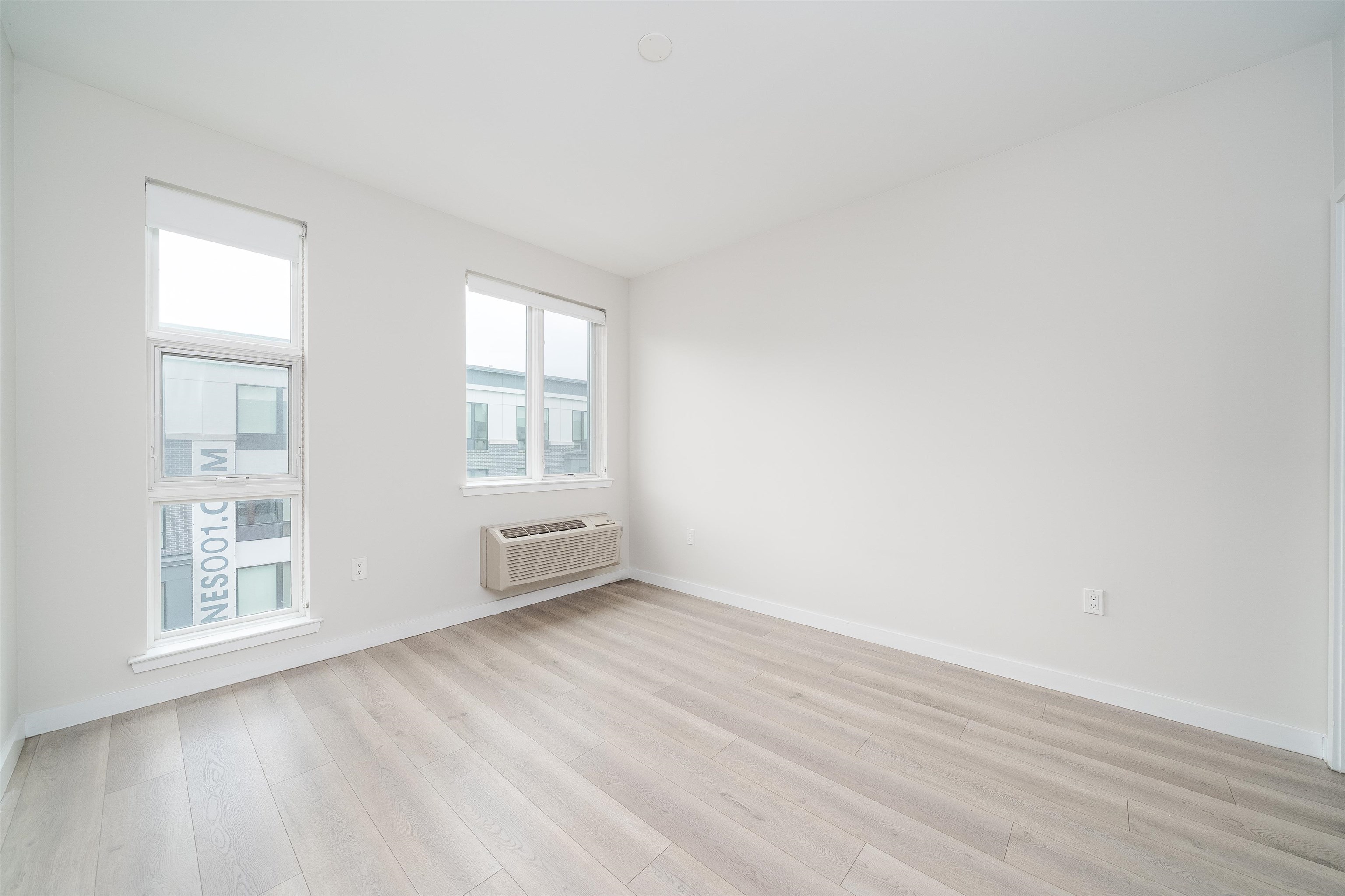 16 Bennett Street, Unit 211 Jersey City, NJ 07304 - Photo 9 of 24 an empty room with windows