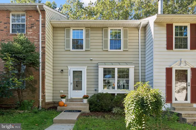 a front view of a house with a yard and glass windows