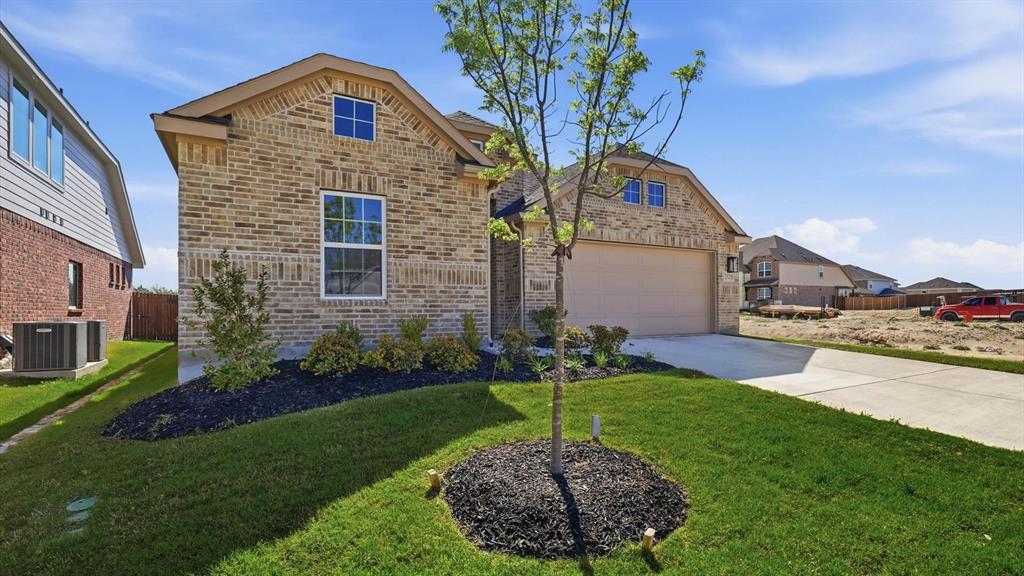 2529 Rivers W Road Anna, TX 75409 - Photo 6 of 40 Brick exterior featuring a two-car garage, concrete driveway, and landscaping with mature plantings