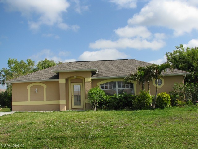5371 17th Avenue Southwest Naples, FL 34116 - Photo 1 of 5 a front view of a house with garden