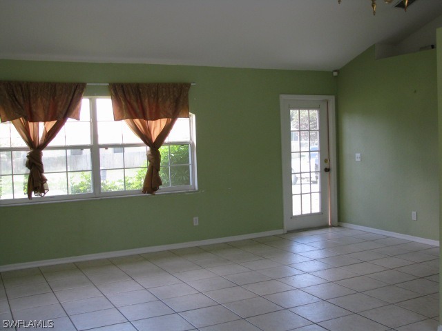 5371 17th Avenue Southwest Naples, FL 34116 - Photo 2 of 5 an empty room with windows and door