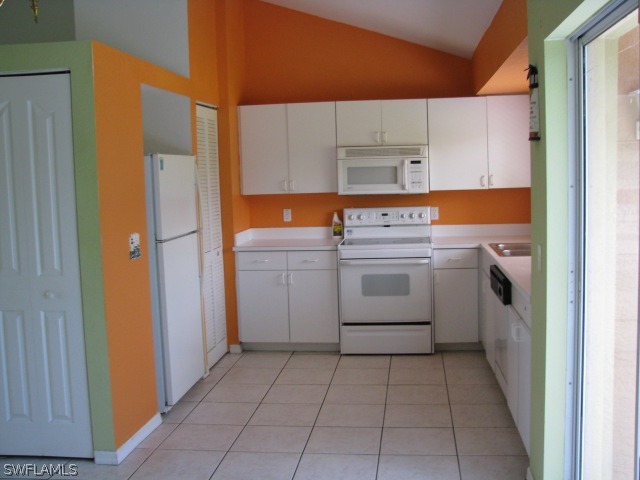 5371 17th Avenue Southwest Naples, FL 34116 - Photo 3 of 5 a utility room with cabinets washer and dryer