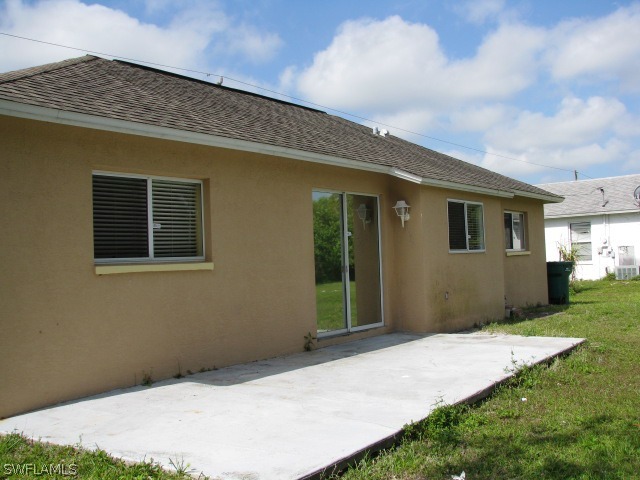 5371 17th Avenue Southwest Naples, FL 34116 - Photo 5 of 5 a front view of a house with garden