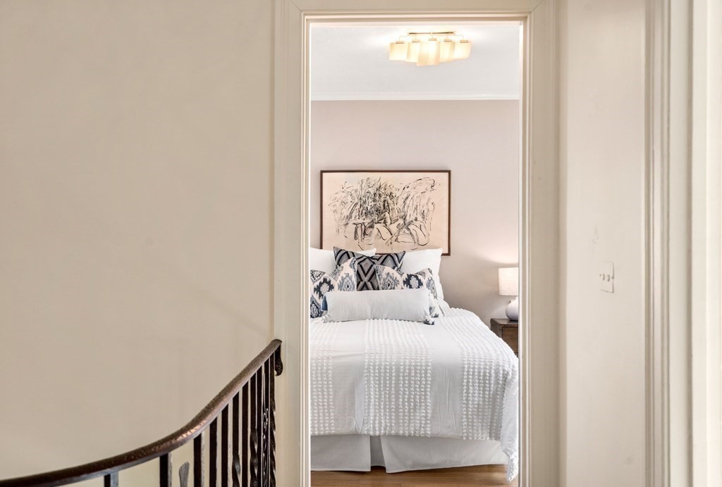 204 Lancaster Terrace Brookline, MA 02446 - Photo 12 of 32 a bedroom with a bed and a painting on the wall