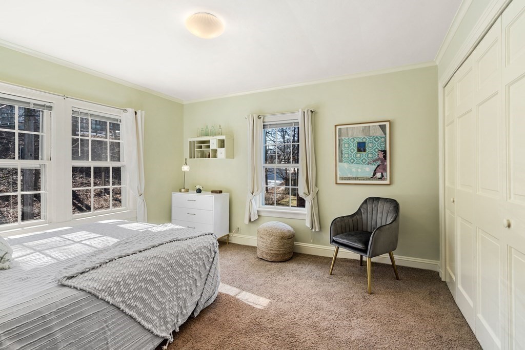 204 Lancaster Terrace Brookline, MA 02446 - Photo 18 of 32 a bedroom with a bed and a chair