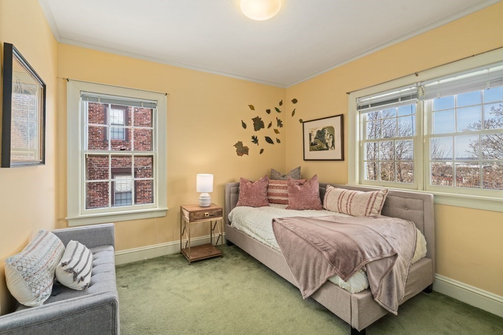 204 Lancaster Terrace Brookline, MA 02446 - Photo 19 of 32 a bedroom with a bed and a couch next to a window