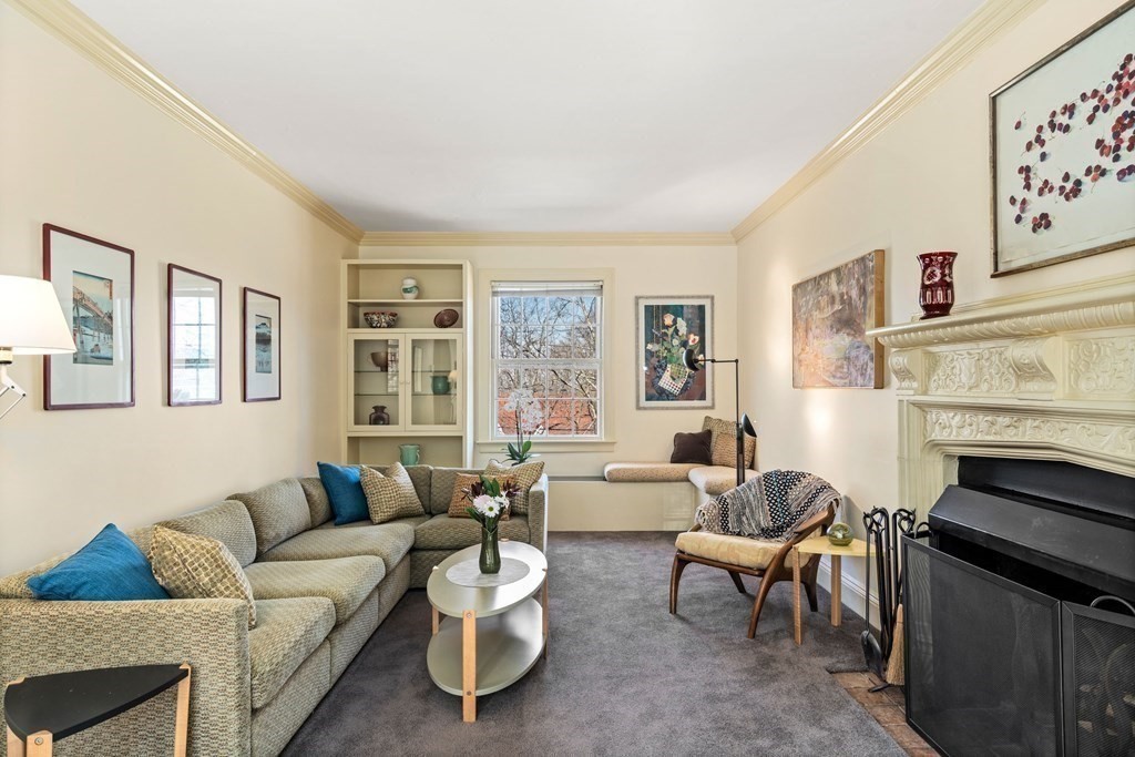 204 Lancaster Terrace Brookline, MA 02446 - Photo 9 of 32 a living room with furniture and a fireplace