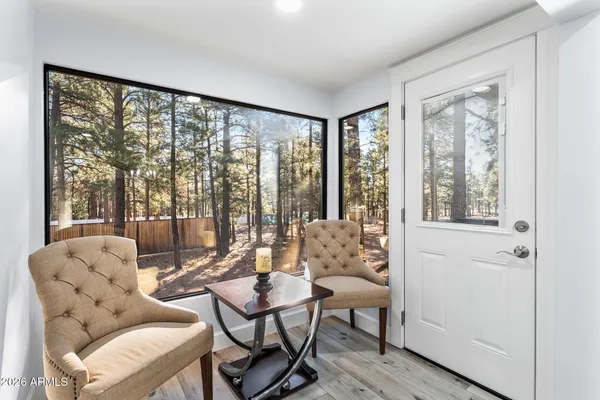 a view of a dining room with furniture window and wooden floor