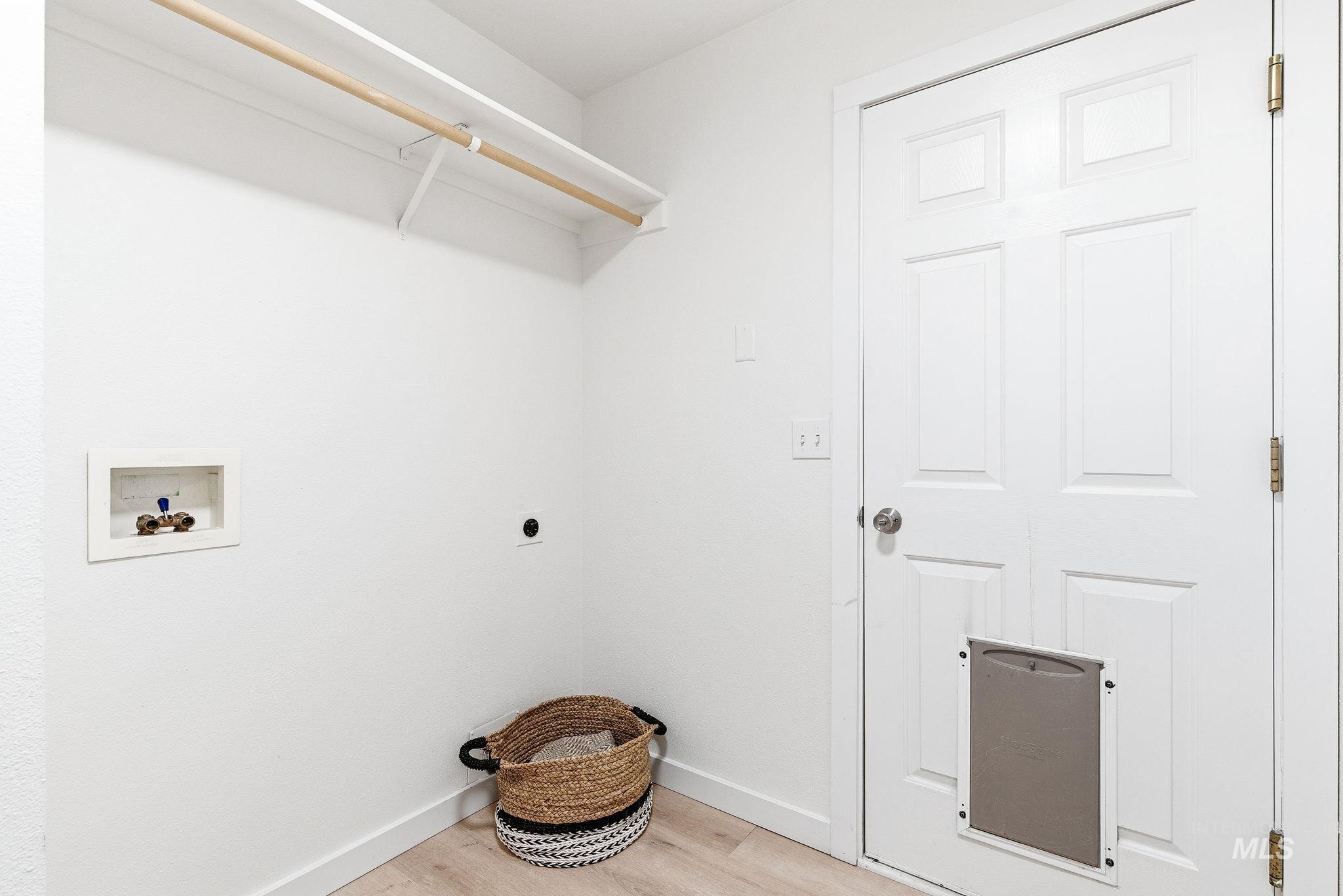 696 West Rams Hill Street Kuna, ID 83634 - Photo 23 of 46 Laundry area featuring light wood finished floors, hookup for a washing machine, and hookup for an electric dryer