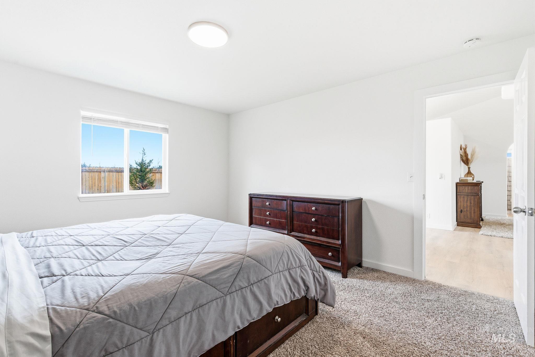 696 West Rams Hill Street Kuna, ID 83634 - Photo 26 of 46 Carpeted bedroom with baseboards