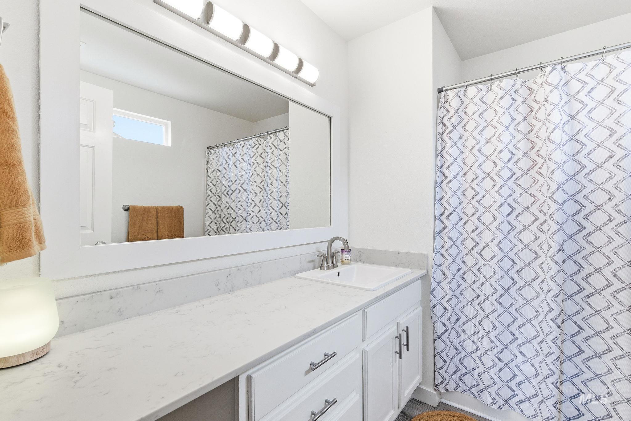 696 West Rams Hill Street Kuna, ID 83634 - Photo 28 of 46 Bathroom with curtained shower and vanity