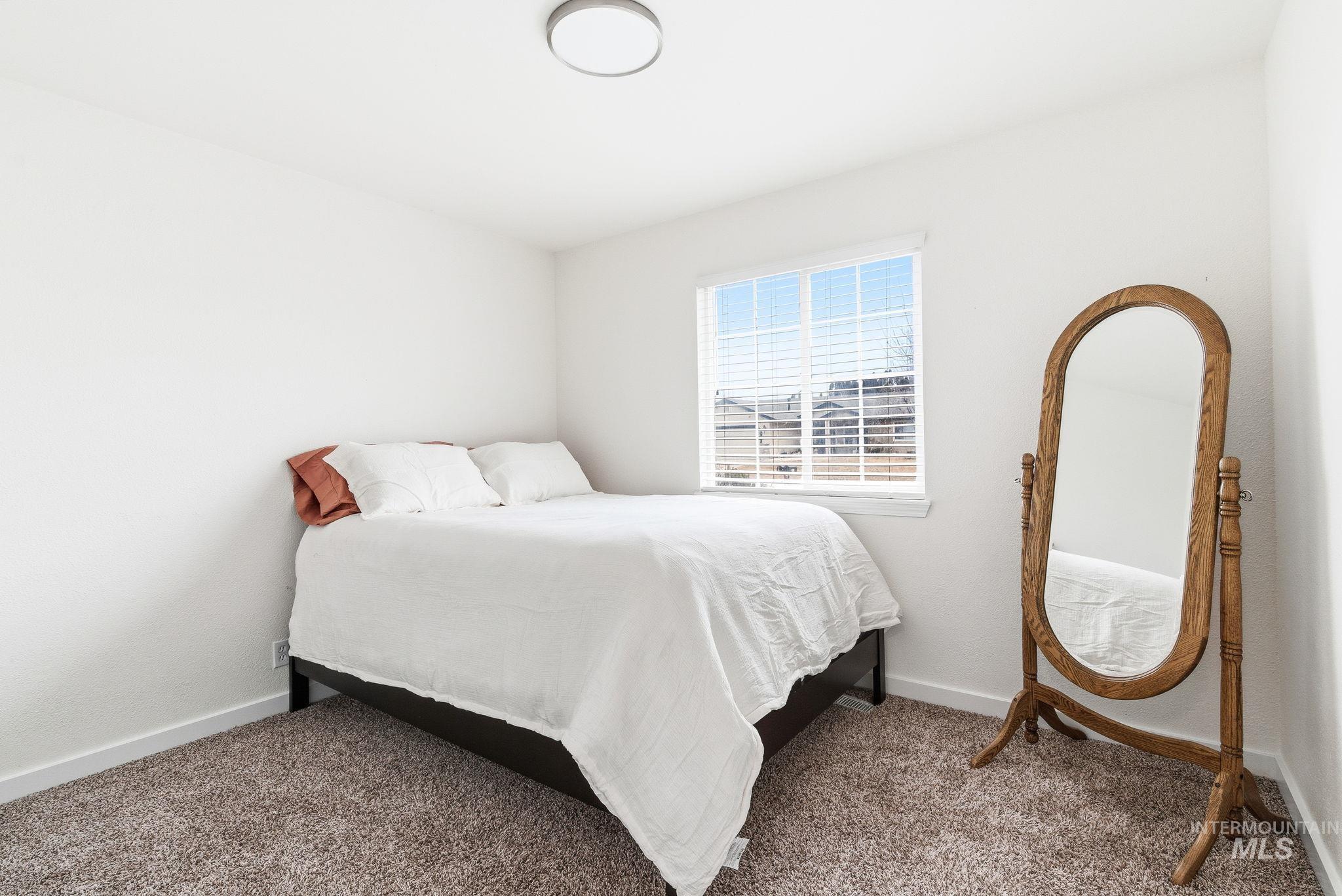 696 West Rams Hill Street Kuna, ID 83634 - Photo 31 of 46 Carpeted bedroom with baseboards
