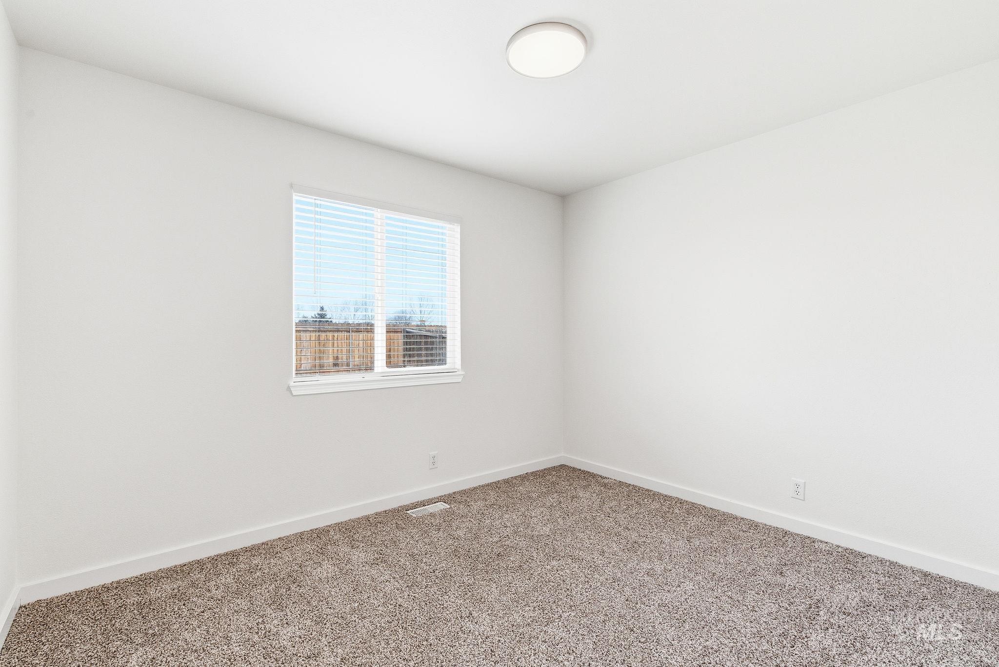 696 West Rams Hill Street Kuna, ID 83634 - Photo 35 of 46 Carpeted spare room with baseboards